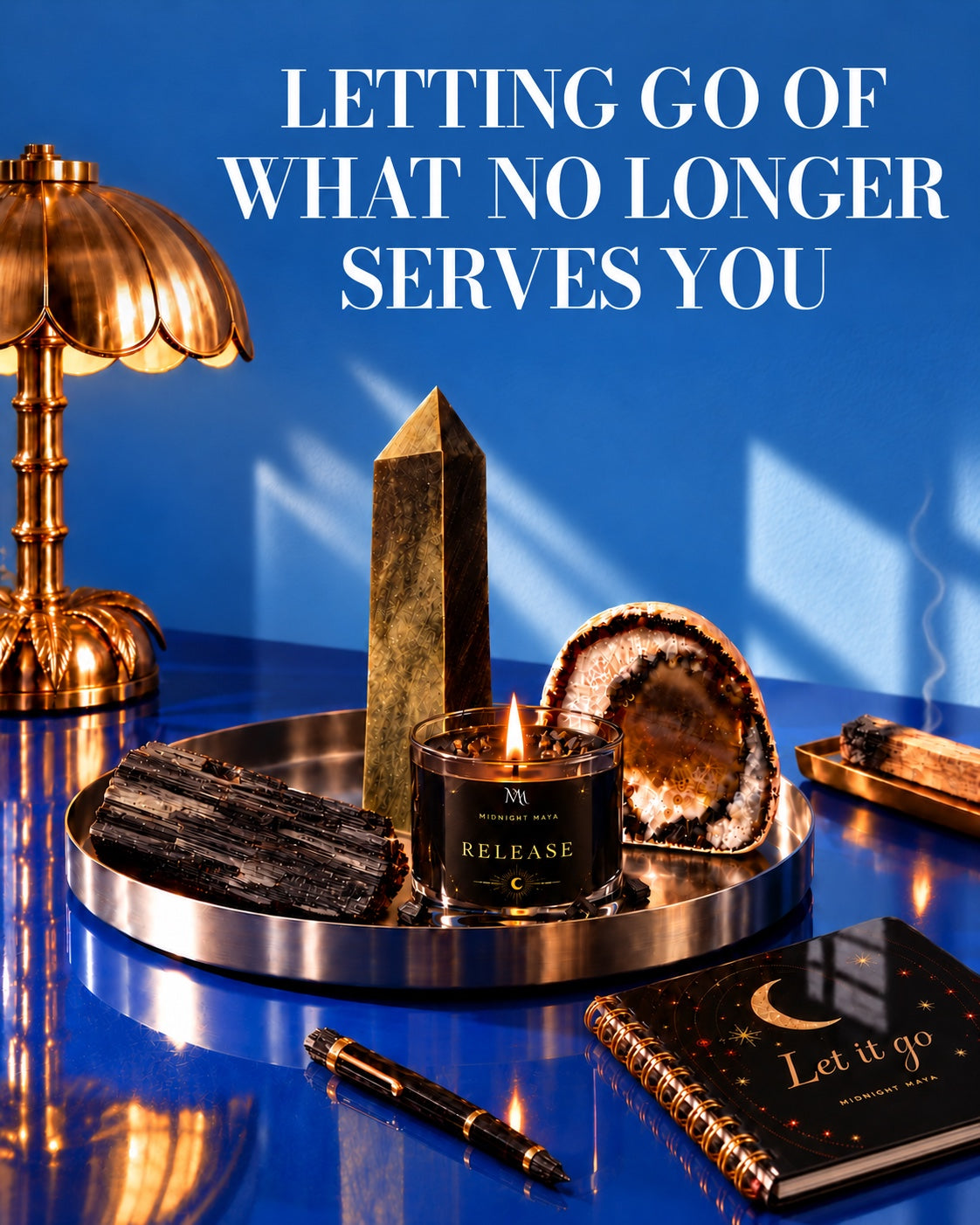 Letting Go of What No Longer Serves You: dark crystals with a Release candle on a blue desk.